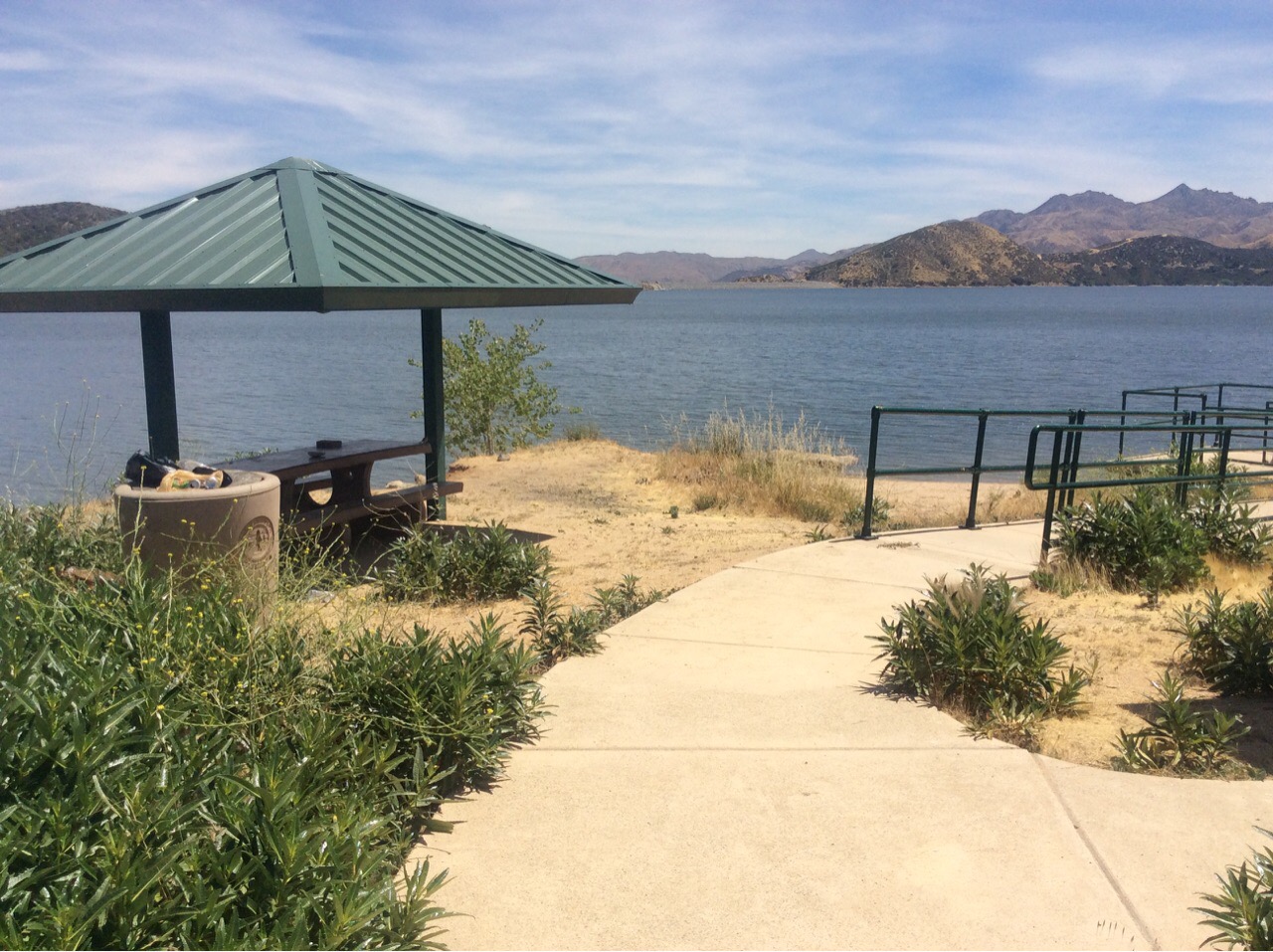 Shaded picnic shelter and path beside the water at Chamise on Silverwood Lake