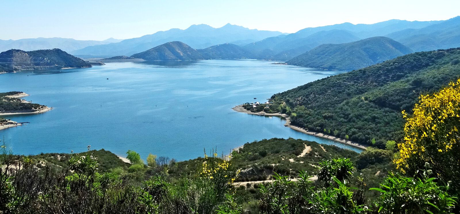Silverwood Lake surrounded by hills in the San Bernardino Mountains, photographed from above the shoreline